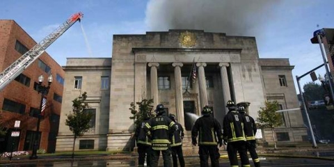 Image of firefighters putting out a temple fire