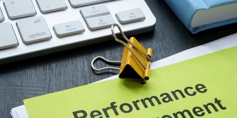 Stack of papers with Performance Improvement Plan PIP.